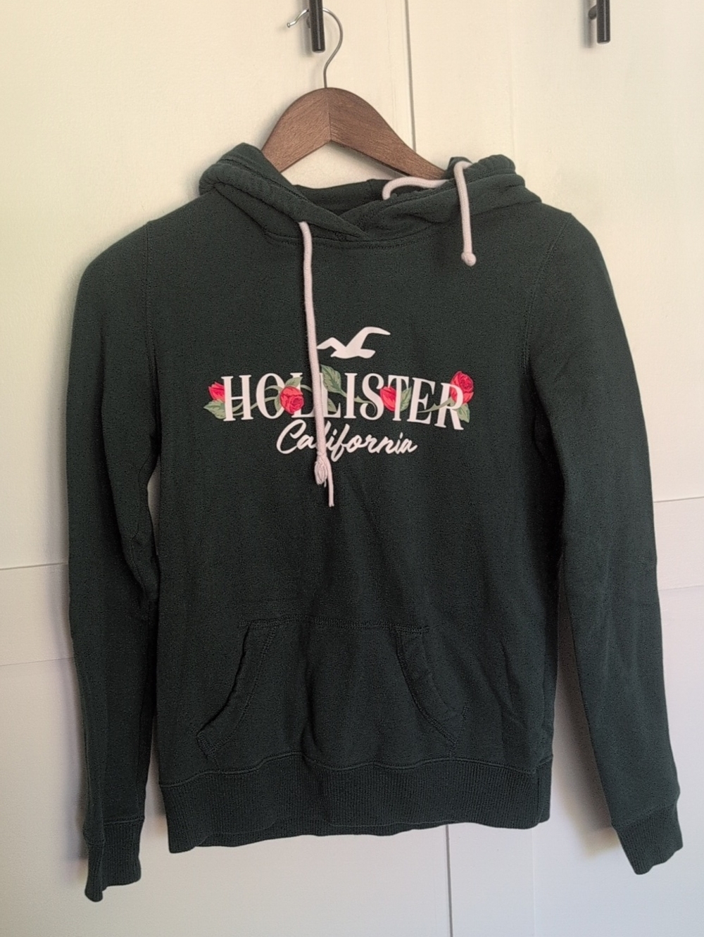 Hollister Women's Forest Green Hoodie with Red And White Floral Logo